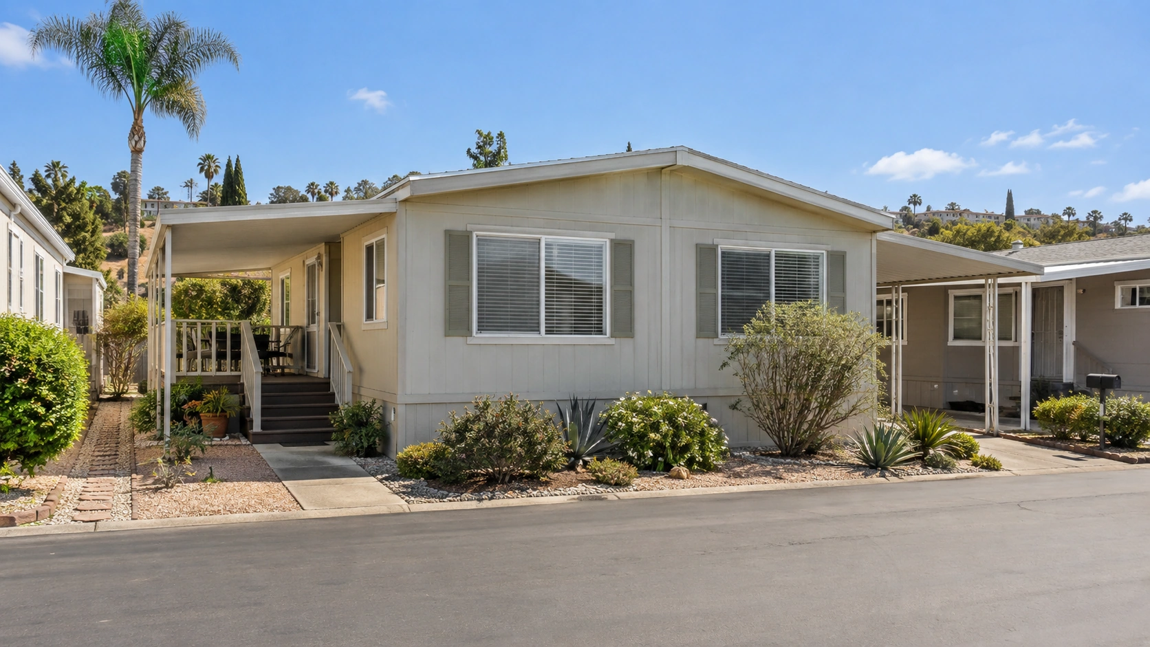 Modest manufactured home with a maintained but lived-in exterior and simple landscaping